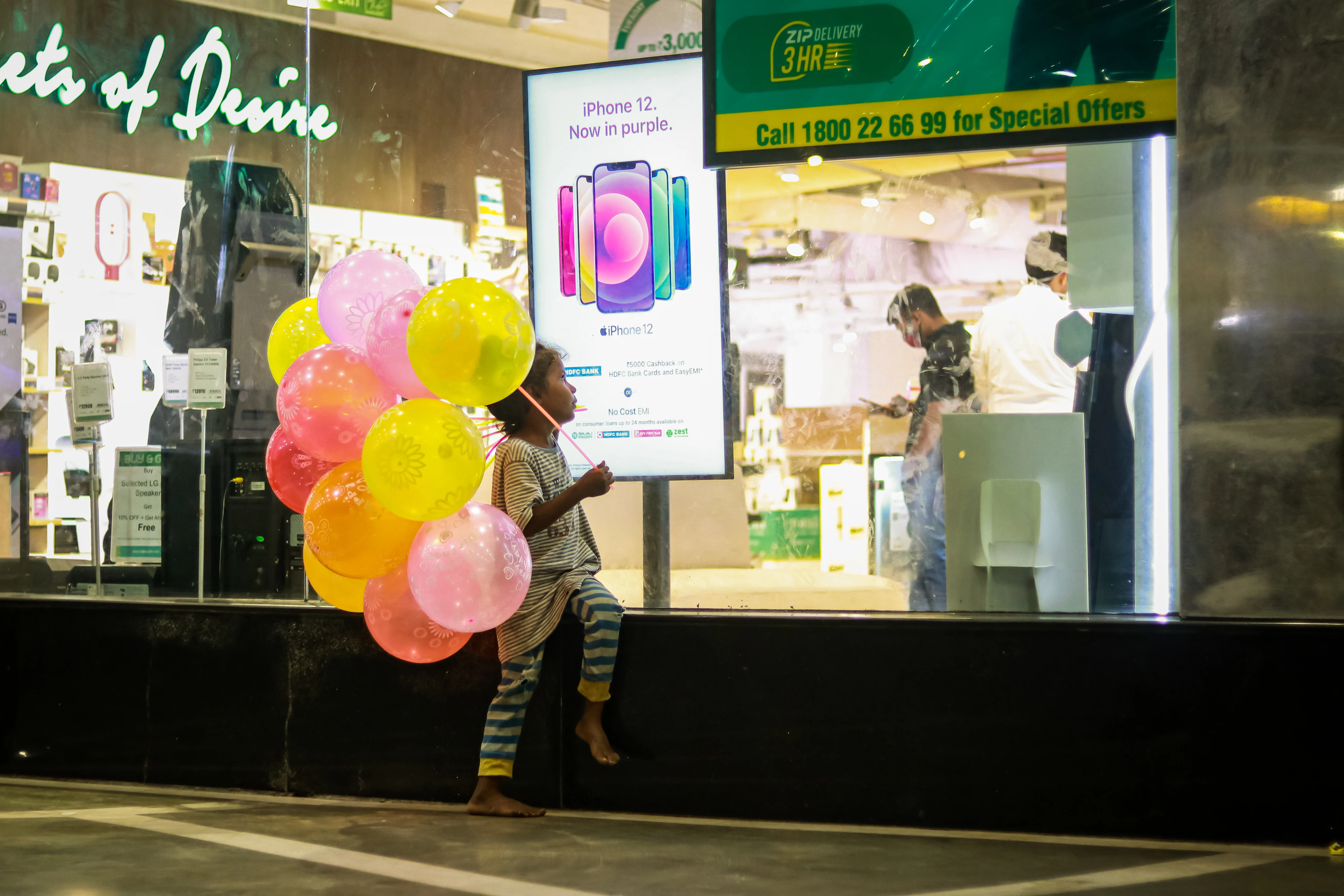 Girl standing outside Apple store looking inside